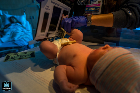 In Ventura, California, a baby gets her footprints taken at the hospital while her mom rests in the background, capturing a moment of their new journey together.