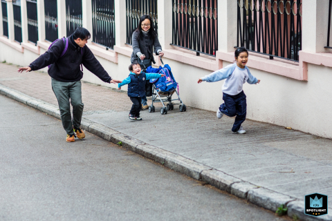 In San Francisco, California, a family enjoys a spirited run together along the urban streets, mom and dad with the kids, capturing the vibrant energy of city life.
