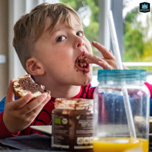 A family photographer captured this candid moment in Dusseldorf, North Rhine-Westphalia, as a young boy enjoys a chocolate bread treat and licks his fingers.