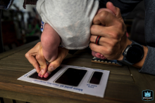 In Ventura, California, mom and dad team up, navigating challenges and laughter as they carefully press their newborn’s foot for a memorable first footprint keepsake.
