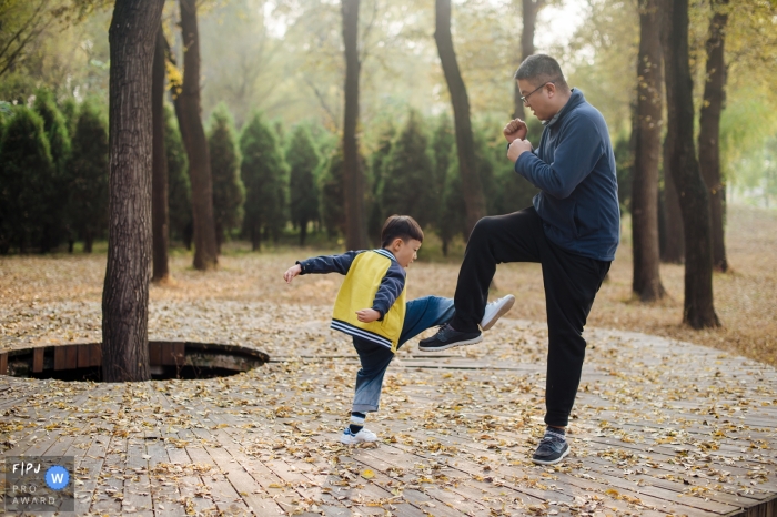 Photo by: <a href="https://www.fpja.com/documentary-family-photography-contests/bai-gang/shanxi/2062951">Bai Gang - China</a> A father and son play fight outside in this picture captured by a Shanxi, China family photojournalist.