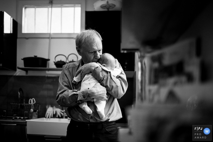 Photo by: <a href="https://www.fpja.com/documentary-family-photography-contests/estelle-chhor/h%C3%A9rault/2066031">Estelle Chhor - France</a> A grandfather holds his infant grandchild in this image created by a Herault family photographer.