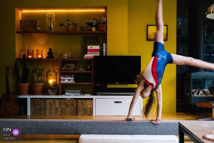 Photo by: <a href="https://www.fpja.com/documentary-family-photography-contests/liesbeth-parlevliet/zuid-holland/2068436">Liesbeth Parlevliet - Netherlands</a> A girl does a cartwheel on a balance beam in this family picture by a Netherlands photographer.