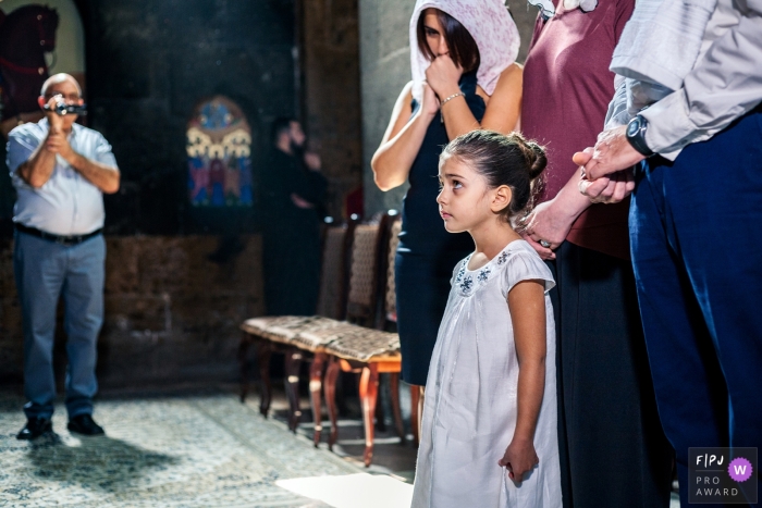 Photo by: <a href="https://www.fpja.com/documentary-family-photography-contests/albert-buniatyan/armenia/2068756">Albert Buniatyan - Armenia</a> A little girl stands with her family during a ceremony in this documentary-style family image recorded by an Armenia photographer.