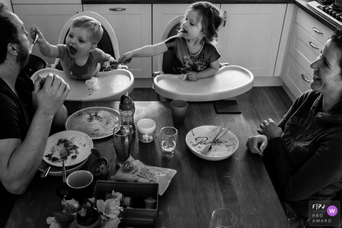Photo by: <a href="https://www.fpja.com/documentary-family-photography-contests/marieke-zwartscholten/zuid-holland/2070196">Marieke Zwartscholten - Netherlands</a> A little boy tries to feed his father in a surprising role reversal in this Family Photojournalist Association contest awarded photo created by a Netherlands family photographer.
