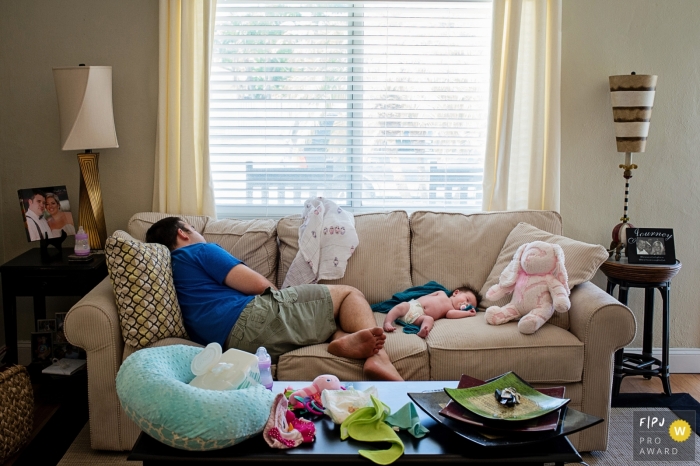 Photo by: <a href="https://www.fpja.com/documentary-family-photography-contests/julie-ambos/key-west/2070731">Julie Ambos - United States</a> A father sleeps on a couch next to his infant in this photograph by a Key West, FL documentary family photographer.