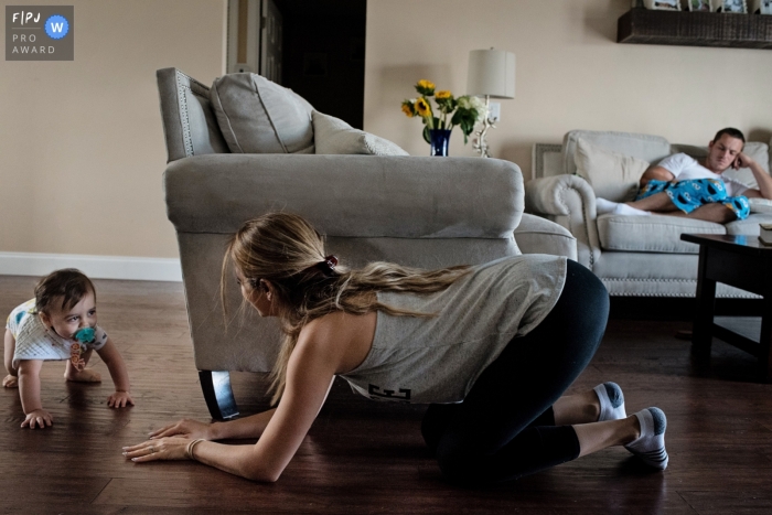 A mother plays with her baby boy on the floor of their living room in this award-winning photo by a Key West family photographer.