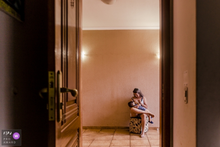 A mother nurses her son in the next room in this photo by an Arapongas family photojournalist. 