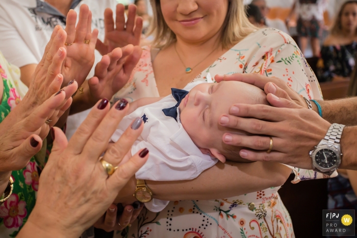 São Paulo family photojournalist captured this photo of a baby being blessed during a church service