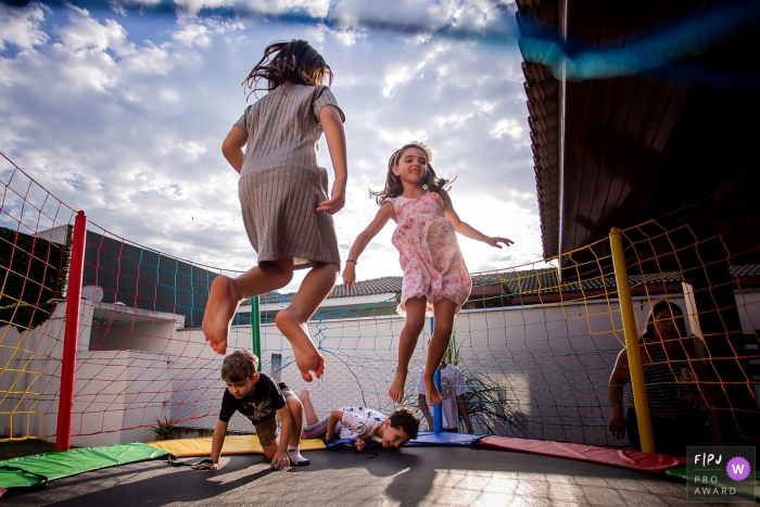 Photo by: <a href="https://www.fpja.com/documentary-family-photography-contests/fernando-noronha/s%C3%A3o-paulo/2081431">Fernando Noronha - Brazil</a> Four children play on a trampoline in this Family Photojournalist Association contest awarded photo created by a Sao Paulo, Brazil family photographer.