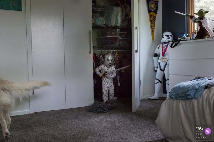 Photo by: <a href="https://www.fpja.com/documentary-family-photography-contests/casie-zalud/boulder/2082736">Casie Zalud - United States</a> A little boy stands in his closet dressed as a knight in this FPJA award-winning image captured by a Boulder family photographer.