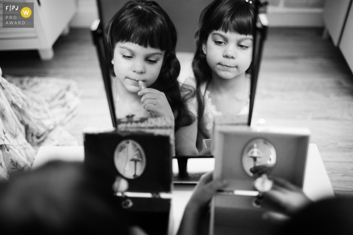 Saint-Petersburg family photojournalist captured this black and white picture of the reflection of twin girls playing with music boxes side by side