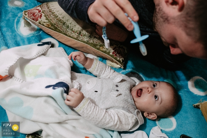 Florianopolis documentary family photographer captured this photo of an infant looking horrified at an approaching pacifier 