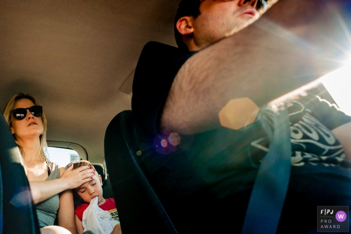 Photo by: <a href="https://www.fpja.com/documentary-family-photography-contests/rafael-rosa/rio-grande-do-sul/2085886">Rafael Rosa - Brazil</a> A mother sits in the back seat with her daughter as her husband drives in this documentary-style family photo captured by a Rio Grande do Sul, Brazil photographer.
