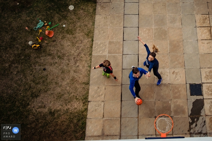Photo by: <a href="https://www.fpja.com/documentary-family-photography-contests/rafael-rosa/rio-grande-do-sul/2085896">Rafael Rosa - Brazil</a> A mother and father play basketball with their son in this Family Photojournalist Association awarded photo by a Rio Grande do Sul, Brazil documentary family photographer.