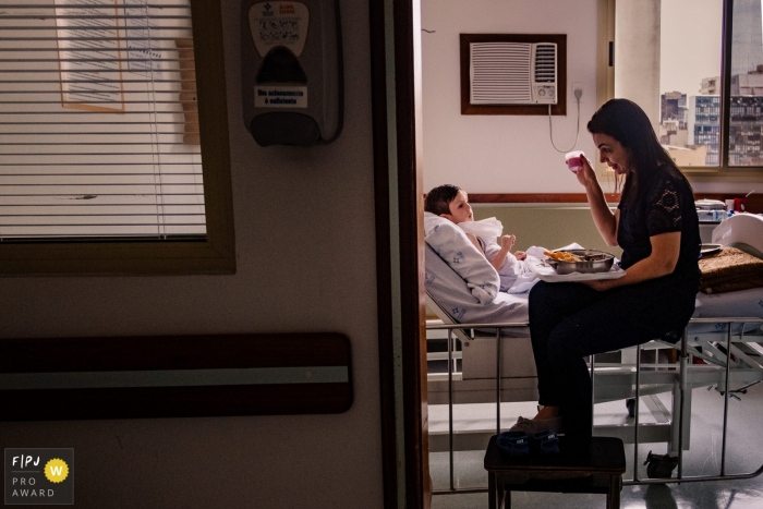 Rio Grande do Sul family photojournalist captured this photo of a mom trying to tempt her child with jello as he rests in a hospital bed.