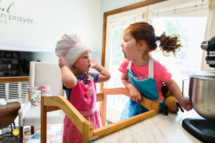 Boulder family photojournalist captured this image of siblings quarreling over who gets to lick the spoon