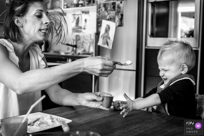 Photo by: <a href="https://www.fpja.com/documentary-family-photography-contests/katrin-k%C3%BCllenberg/dusseldorf/2086451">Katrin Küllenberg - Germany</a> This black and white photo of a toddler refusing to eat his yogurt was captured by a North Rhine-Westphalia documentary family photographer