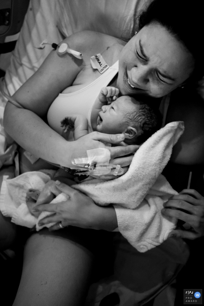 Photo by: <a href="https://www.fpja.com/documentary-family-photography-contests/morgana-secco/london/2087431">Morgana Secco - United Kingdom</a> This black and white photo of a mother cradling her newborn was captured by a London documentary family photographer