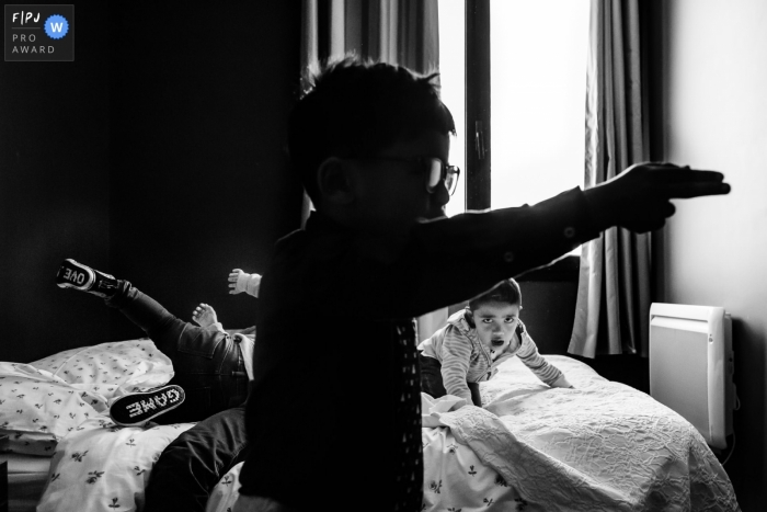 Photo by: <a href="https://www.fpja.com/documentary-family-photography-contests/annie-gozard/paris/2087681">Annie Gozard - France</a> Île-de-France documentary family photographer captured this black and white photo of a trio of boys playing a game on a bed