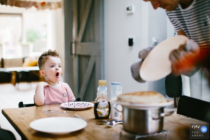 Photo by: <a href="https://www.fpja.com/documentary-family-photography-contests/jolanda-boer/zuid-holland/2088241">Jolanda Boer - Netherlands</a> This photo of a toddler who is excited for his pancake breakfast was captured by a Netherlands documentary family photographer