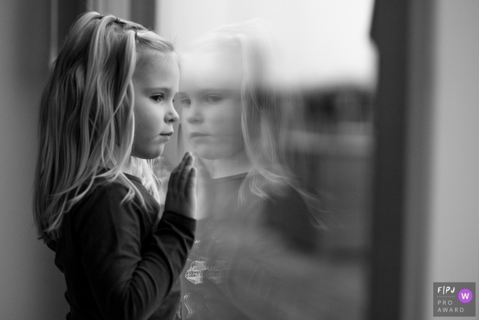 Photo by: <a href="https://www.fpja.com/documentary-family-photography-contests/marcel-kolenbrander/utrecht/2089811">Marcel Kolenbrander - Netherlands</a> A little girl looks out a large window in this family picture by an Utrecht, Netherlands photographer.