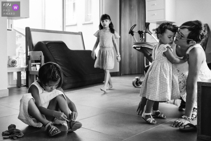 Photo by: <a href="https://www.fpja.com/documentary-family-photography-contests/marine-poron/paris/2092491">Marine Poron - France</a> Three little girls get ready with their mother in this photograph by a Paris, France documentary family photographer.