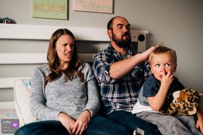 A little boy picks his nose while his mother makes a face at him in this picture captured by a Boulder, CO family photojournalist. 