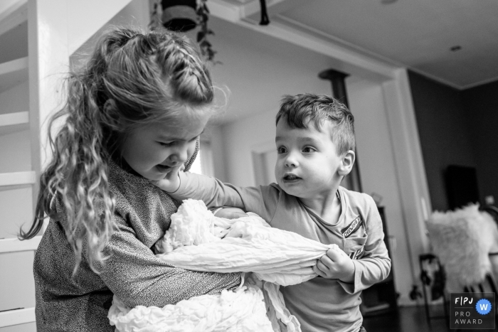 Photo by: <a href="https://www.fpja.com/documentary-family-photography-contests/angeline-dobber-jansen/gelderland/2093511">Angeline Dobber-Jansen - Netherlands</a> A brother and sister fight over a blanket in this photograph created by a Gelderland, Netherlands family photojournalist.