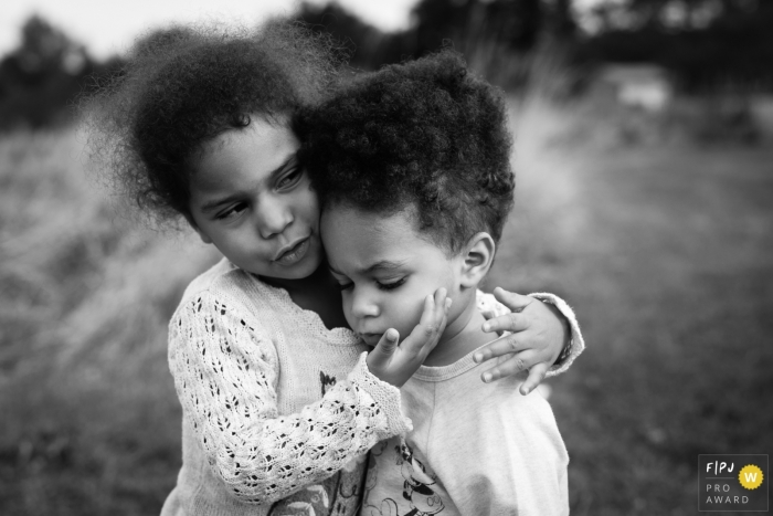Photo by: <a href="https://www.fpja.com/documentary-family-photography-contests/alice-chapman/cambridgeshire/2095961">Alice Chapman - United Kingdom</a> A little girl holds her sister in this documentary-style family image recorded by a Cambridgeshire, England photographer.