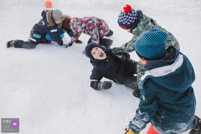 Photo by: <a href="https://www.fpja.com/documentary-family-photography-contests/elena-petrova/saint-petersburg/2097521">Elena Petrova - Russia</a> Five boys play outside in the snow together in this family picture by a Saint Petersburg, Russia photographer.