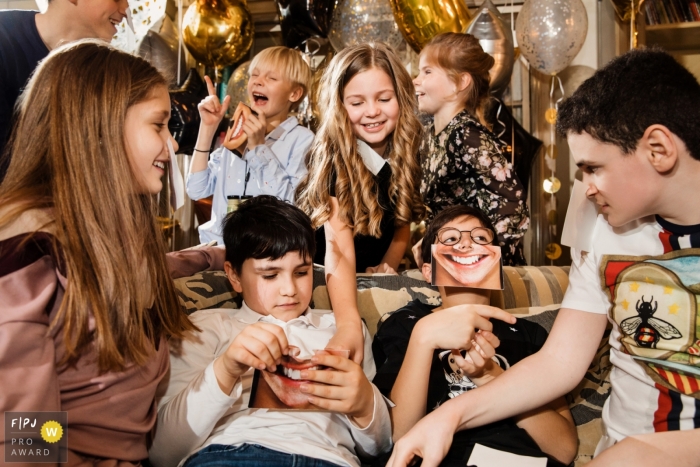 Photo by: <a href="https://www.fpja.com/documentary-family-photography-contests/elena-petrova/saint-petersburg/2097566">Elena Petrova - Russia</a> Children play and laugh during a birthday party in this FPJA award-winning image captured by a Saint Petersburg, Russia family photographer.