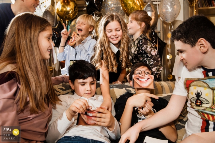 Children play and laugh during a birthday party in this FPJA award-winning image captured by a Saint Petersburg, Russia family photographer. 