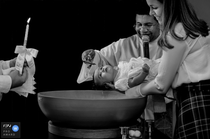 Photo by: <a href="https://www.fpja.com/documentary-family-photography-contests/alex-souza/minas-gerais/2099379">Alex Souza - Brazil</a> Minas Gerais, Brazil baby baptism photography in black and white.