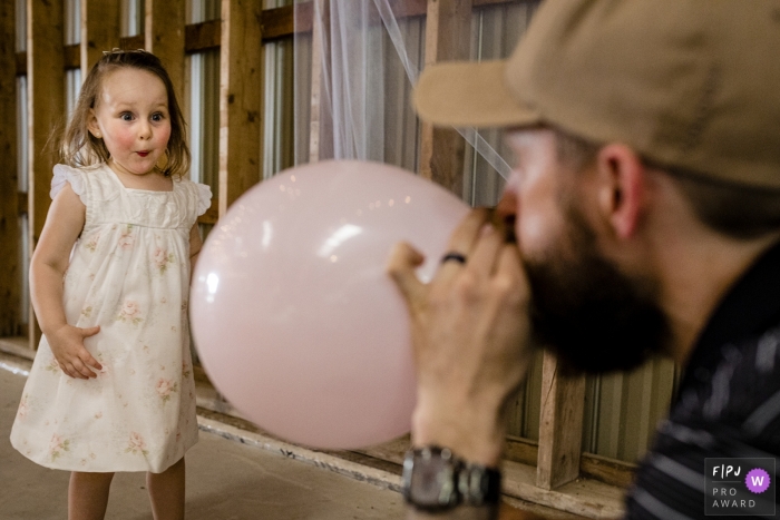 Canada family photographer - girl reacts in surprise at balloon in Ontario