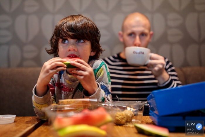 England family reportage photography of a coffee break and chomping on a watermelon slice 