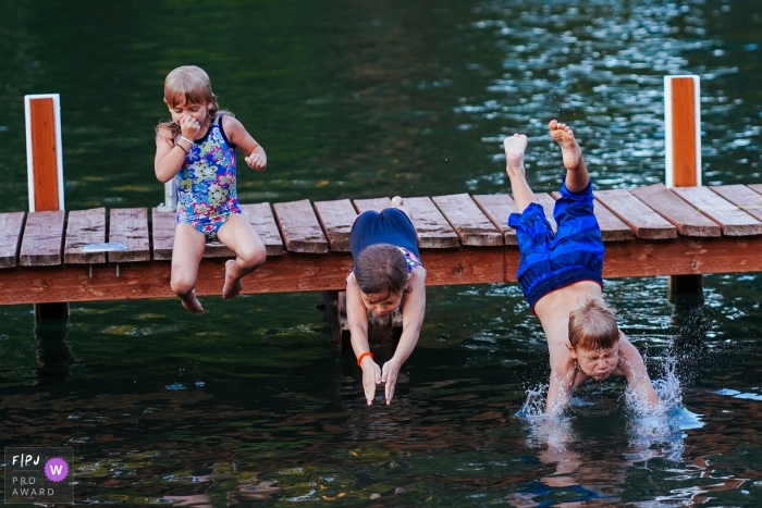 Photo by: <a href="https://www.fpja.com/documentary-family-photography-contests/ron-storer/seattle/2100810">Ron Storer - United States</a> Seattle Washington documentary family photos of kids jumping into the water