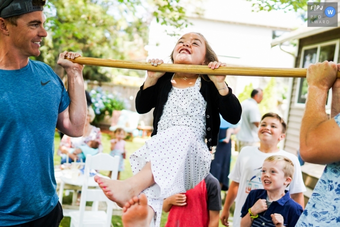 Photo by: <a href="https://www.fpja.com/documentary-family-photography-contests/ron-storer/seattle/2100814">Ron Storer - United States</a> Washington family photography of pull-ups session in the backyard.