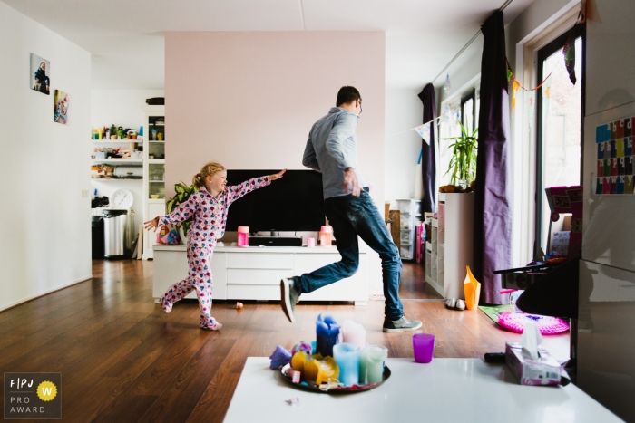 Photo by: <a href="https://www.fpja.com/documentary-family-photography-contests/charlene-van-der-gracht/amsterdam/2100980">Charlene van der Gracht - Netherlands</a> Amsterdam family photoshoot session with girl chasing around dad in the house.