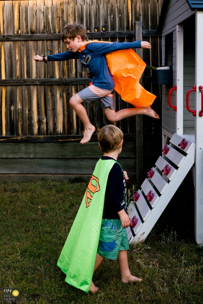 Kent England family photography from the backyard | Two boys playing superheroes