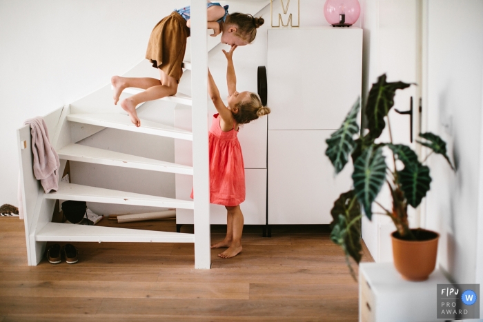 Photo by: <a href="https://www.fpja.com/documentary-family-photography-contests/jolanda-boer/zuid-holland/2101252">Jolanda Boer - Netherlands</a> Zuid Holland Netherlands Day in the life-shoot with two sisters playing on some steps