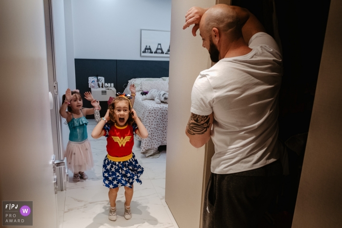 Photo by: <a href="https://www.fpja.com/documentary-family-photography-contests/thiago-braga/florianopolis/2101389">Thiago Braga - Brazil</a> Father and daughter excited for heroes birthday party | Santa Catarina family photographer