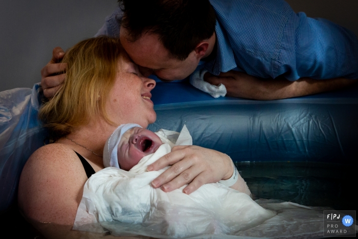 Netherlands mom and dad holding their baby for the first time after birthing session.