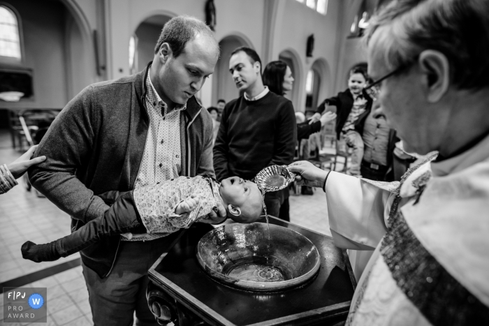 Photo by: <a href="https://www.fpja.com/documentary-family-photography-contests/kobe-vanderzande/limburg/2101623">Kobe Vanderzande - Belgium</a> Flanders water baptism photos in black and white inside the church.