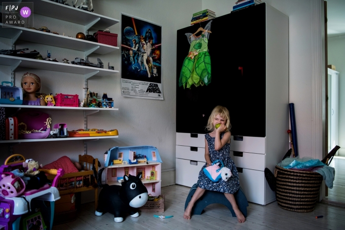 Copenhagen Denmark young girl alone in her room with toys - In home family pictures - DITL