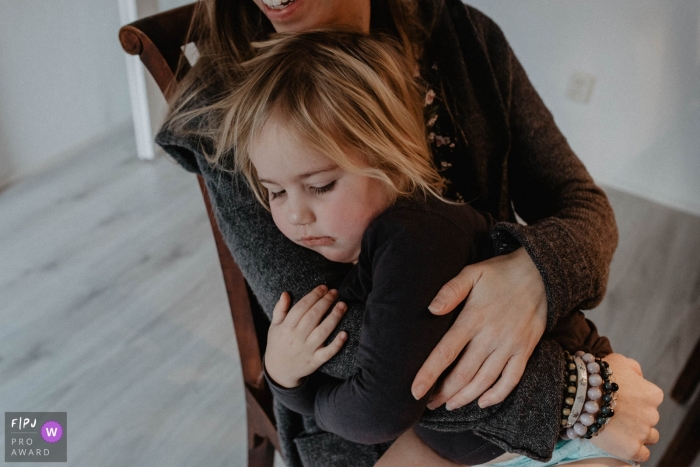 Photo by: <a href="https://www.fpja.com/documentary-family-photography-contests/marjolein-roossien/groningen/2101756">Marjolein Roossien - Netherlands</a> Girl is feel safe and comfortable being held by her mother | Netherlands Family Photography
