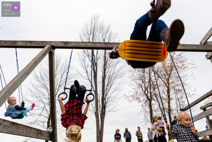 Photo by: <a href="https://www.fpja.com/documentary-family-photography-contests/ang-waterton/ontario/2101827">Ang Waterton - Canada</a> Ontario kids in varying stages of swinging - Family outing photography in Canada