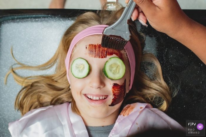 Young girl enjoys a day at the spa with cucumbers on eyes | Sao Paulo Family Session