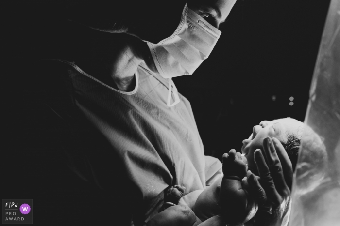 Photo by: <a href="https://www.fpja.com/documentary-family-photography-contests/ana-paula-faria/sao-paulo/2101881">Ana Paula Faria - Brazil</a> Sao Paulo Birth Photography | Newborn is held