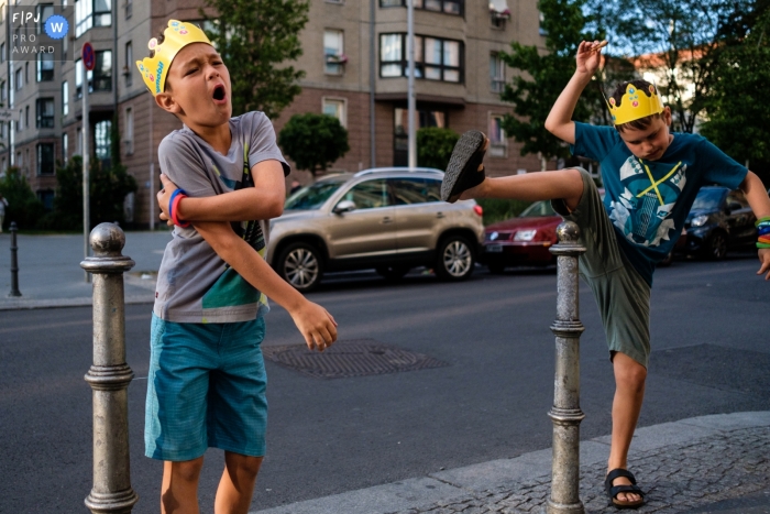 Photo by: <a href="https://www.fpja.com/documentary-family-photography-contests/jess-haverkamp/berlin/2102113">Jess Haverkamp - Germany</a> Boys play on the streets of Berlin on a family outing | Germany Family Photographer